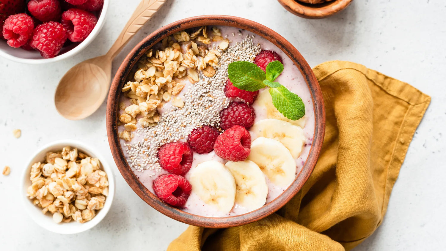 smoothie bowl toped with seeds, berries, bananas, and granola