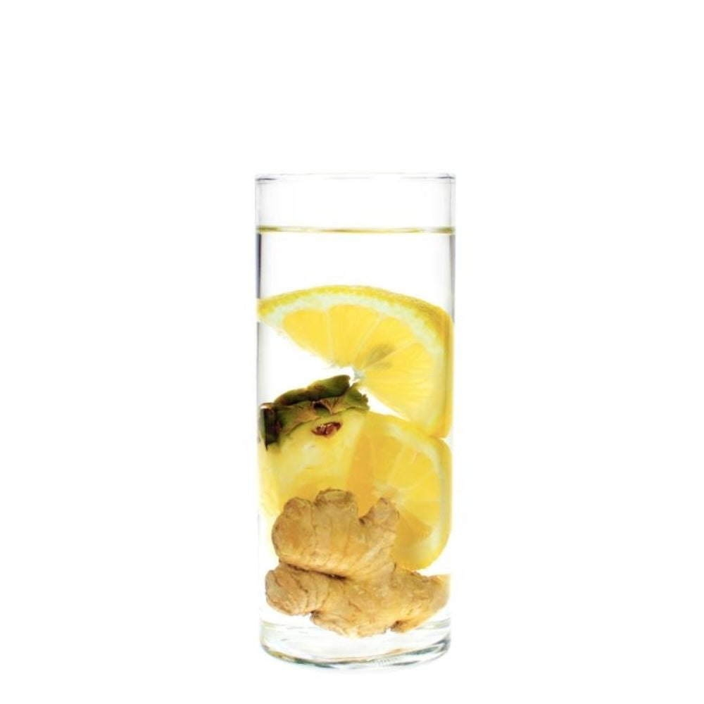 Lemon, pineapple, and ginger floating in water in a clear glass