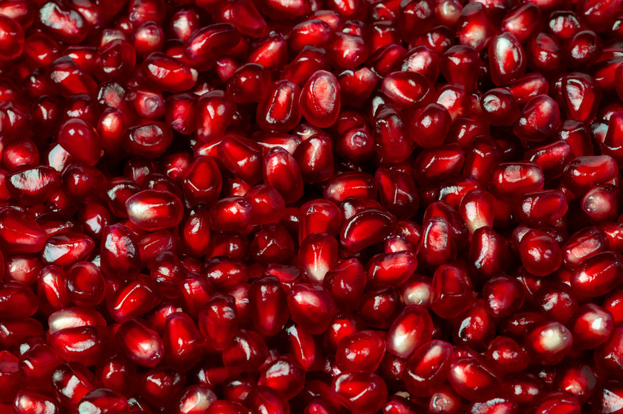 Close-up of glistening red pomegranate arils