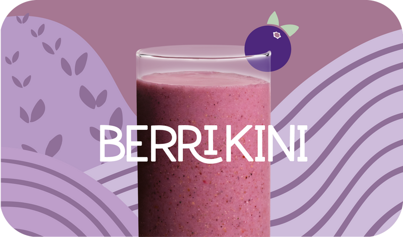Blended Berrikini smoothie in glass, deep purple color with berry design - Frozen Garden keto berry smoothie.
