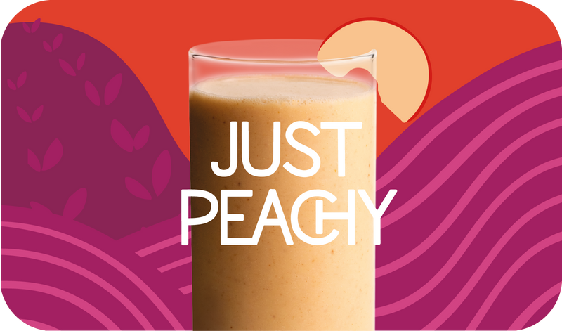 Blended Just Peachy smoothie in glass, soft orange-pink color with peach design - Frozen Garden healthy fruit smoothie.