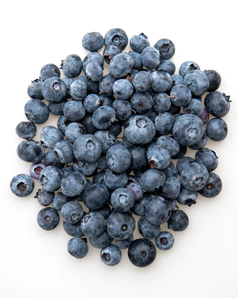 Fresh ripe blueberries piled on a white background
