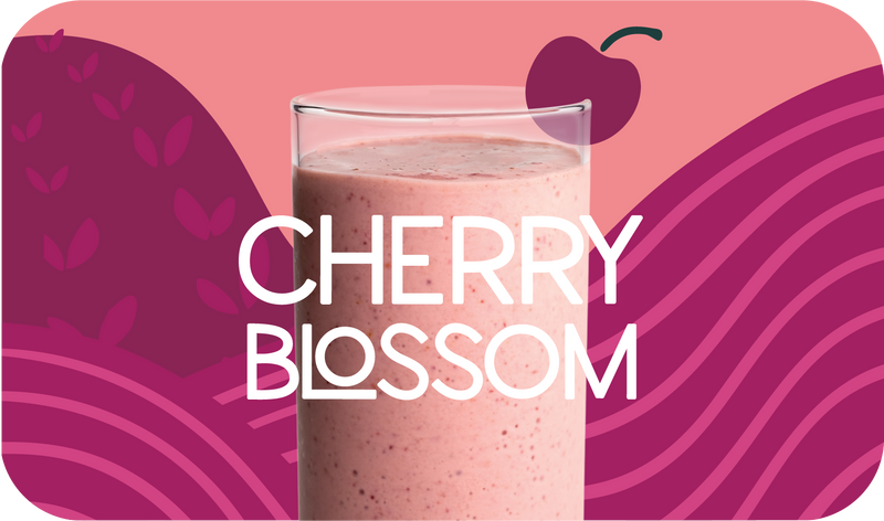 Blended Cherry Blossom smoothie in glass, soft pink color with cherry and citrus design - Frozen Garden healthy fruit smoothie.