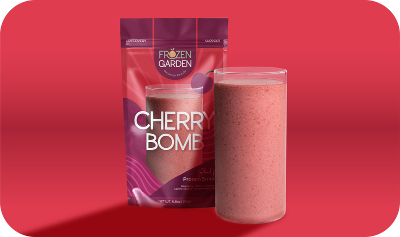 Cherry Bomb smoothie pouch beside blended glass - Frozen Garden ready to blend smoothie with cherry and mango.