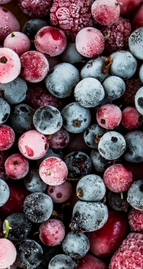 Close-up of frozen berries including blueberries, raspberries, and blackberries.