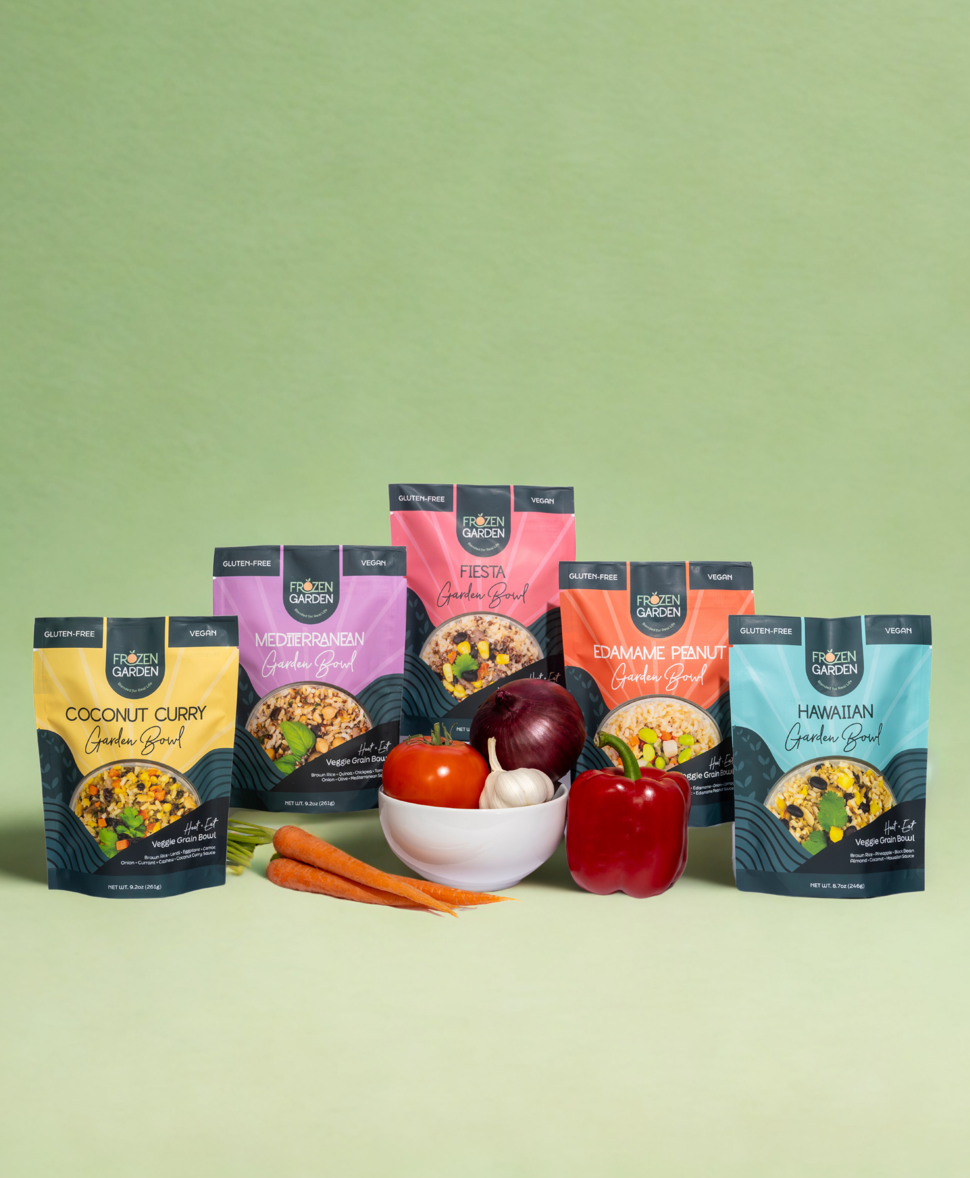 Assorted packages of Frozen Garden Garden Bowls on a green background