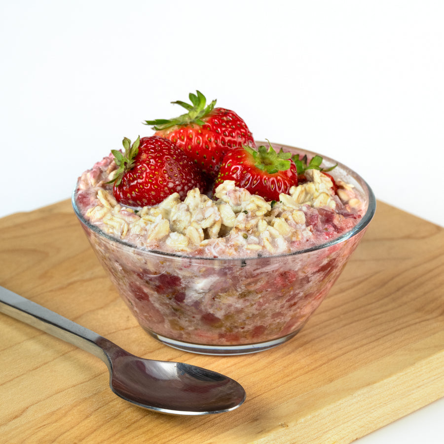 Bowl of Frozen Garden Strawberry Fig premade overnight oats topped with fresh strawberries