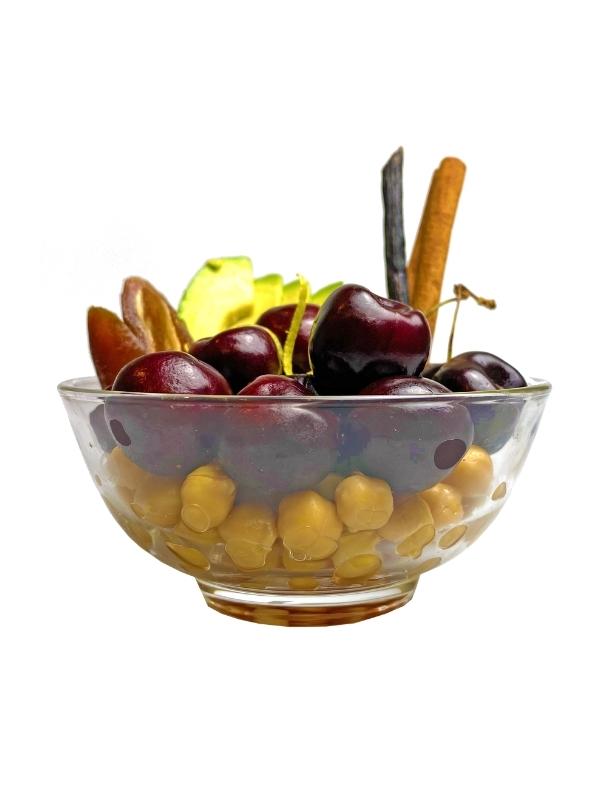 Cherry Cheesecake Delite ingredients layered in clear bowl: cherries, chickpeas, almonds and avocado - Frozen Garden.