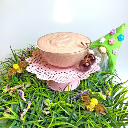 prepared Cherry Cheesecake Delite in clear glass bowl on a spring setting. 